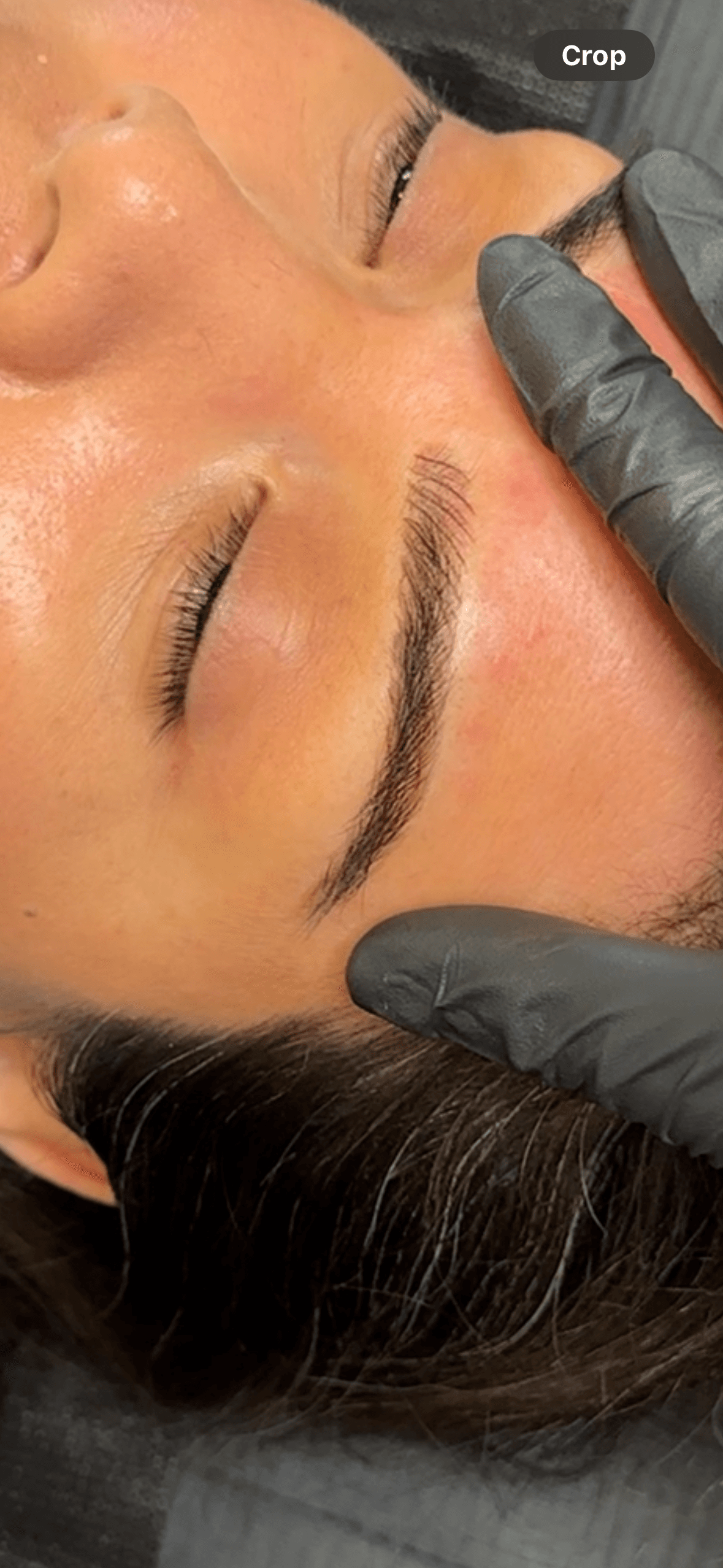 Healed microblading on warm medium skin, close-up showing settled hair strokes